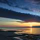 Sunset and dusk over the ocean with clouds