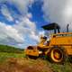 Tractors under skies and clouds